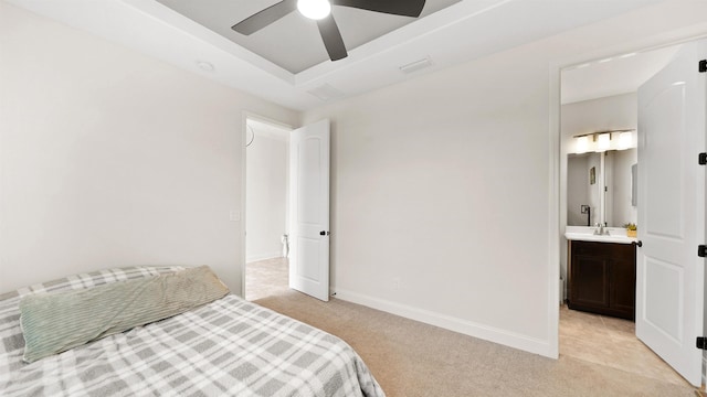 carpeted bedroom with ensuite bath, ceiling fan, and sink