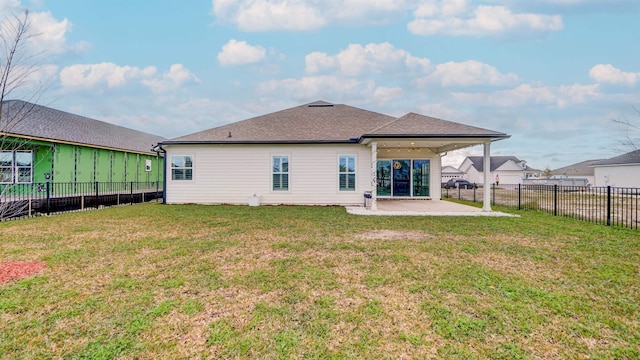 rear view of house featuring a patio area and a yard