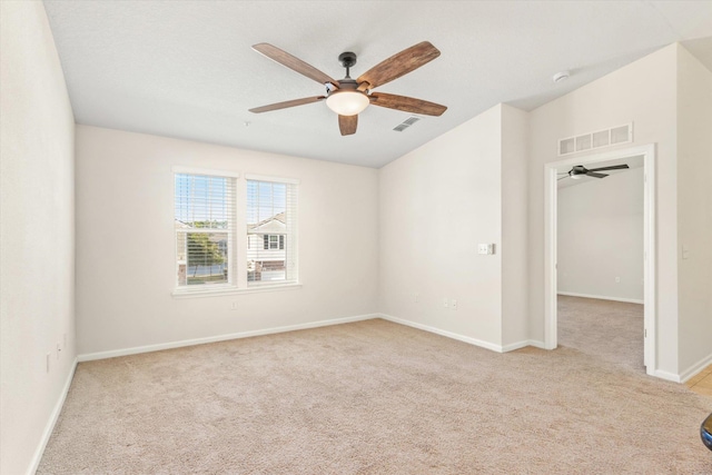 carpeted spare room with ceiling fan