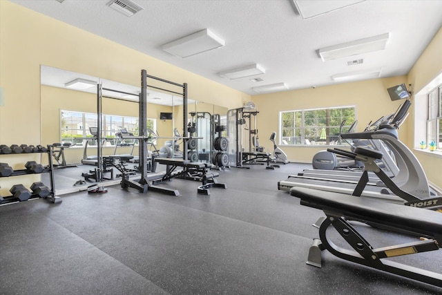 exercise room featuring a textured ceiling