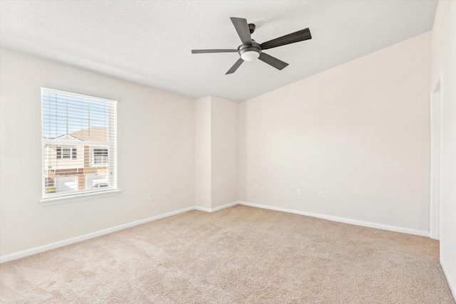 carpeted empty room with a textured ceiling and ceiling fan