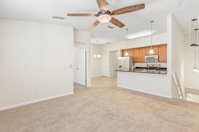 unfurnished living room featuring ceiling fan with notable chandelier, light colored carpet, and sink