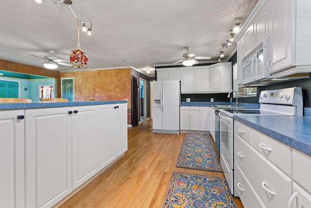 kitchen featuring light wood finished floors, a ceiling fan, white appliances, and white cabinetry