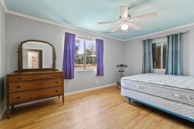 bedroom featuring ceiling fan, baseboards, ornamental molding, and wood finished floors