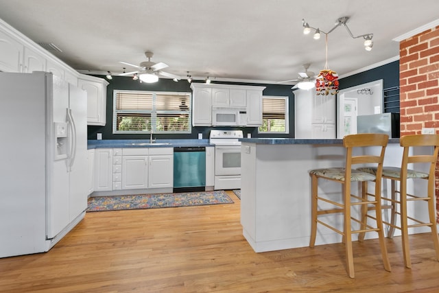 kitchen featuring dark countertops, a ceiling fan, white cabinetry, and white appliances