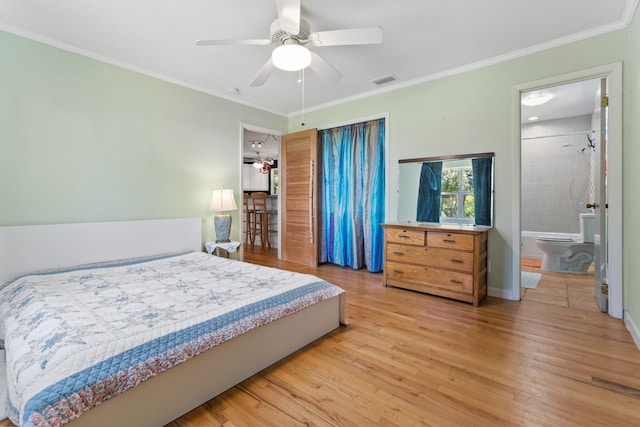 bedroom featuring a ceiling fan, ornamental molding, visible vents, and light wood-style flooring