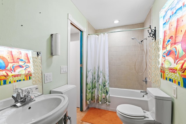 full bath with tile patterned flooring, toilet, shower / bath combo, and a sink