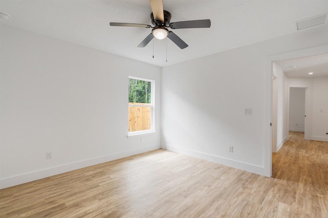 spare room featuring light hardwood / wood-style flooring and ceiling fan