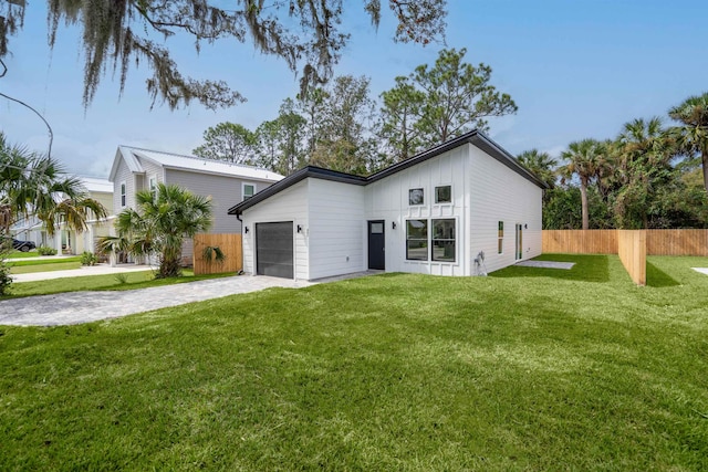 view of front of property featuring a garage and a front yard