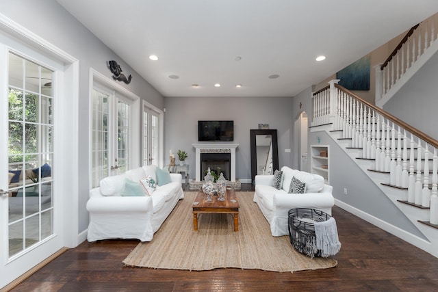 living room with french doors, plenty of natural light, and dark wood-type flooring