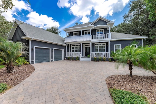 view of front of house with a porch, a balcony, and a garage