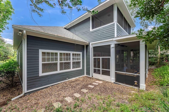 back of property with a sunroom