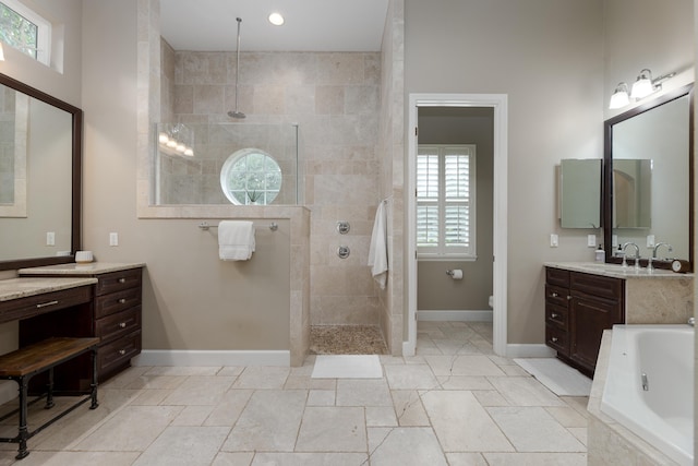 bathroom featuring vanity and separate shower and tub