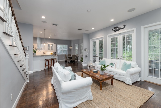 living room featuring dark wood-type flooring and french doors