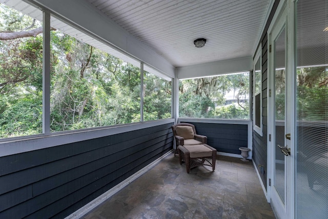 unfurnished sunroom featuring a healthy amount of sunlight and wood ceiling