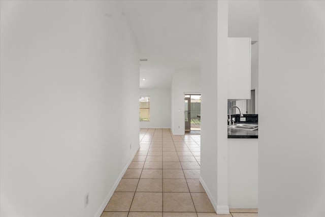980 Windward Way, Saint Augustine, FL 32080 - hallway featuring a sink, light tile patterned floors, and baseboards