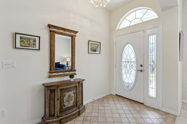 foyer entrance featuring light tile patterned floors and baseboards