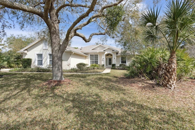 view of front facade with a front lawn and stucco siding