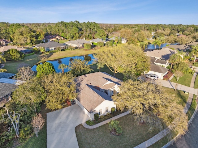 bird's eye view with a wooded view and a water view