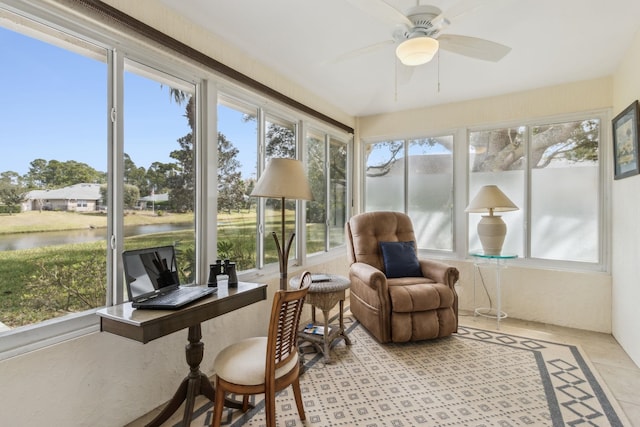 sunroom featuring a ceiling fan, a water view, and plenty of natural light