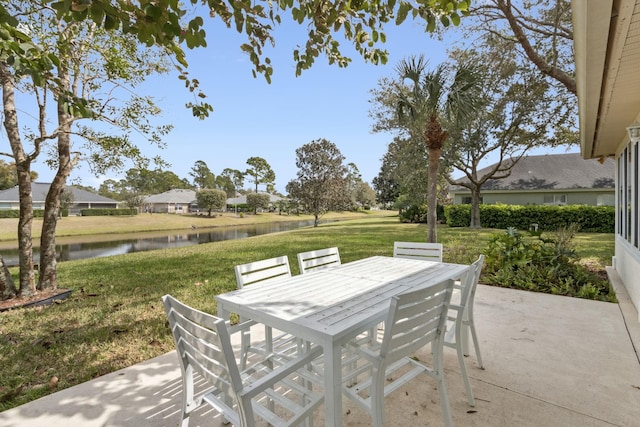 view of patio with outdoor dining area and a water view