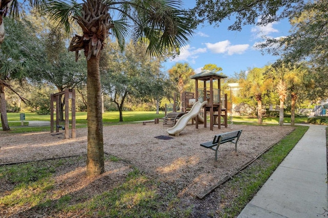 community jungle gym featuring a lawn