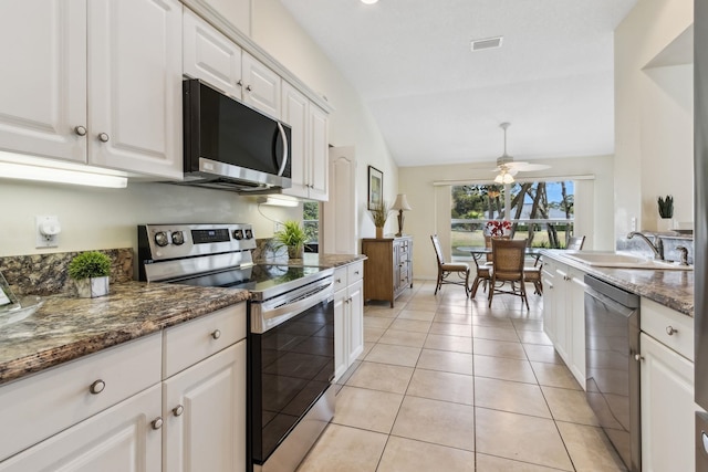 kitchen featuring light tile patterned floors, ceiling fan, stainless steel appliances, visible vents, and white cabinets