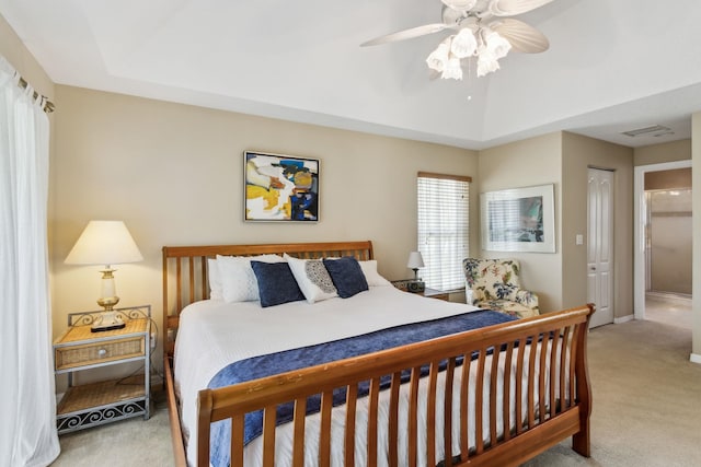 bedroom featuring ceiling fan, lofted ceiling, light colored carpet, visible vents, and baseboards