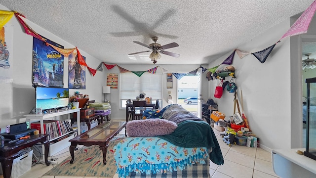 tiled living room featuring a textured ceiling and ceiling fan