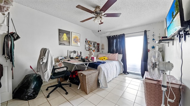 tiled bedroom featuring ceiling fan, multiple windows, and a textured ceiling