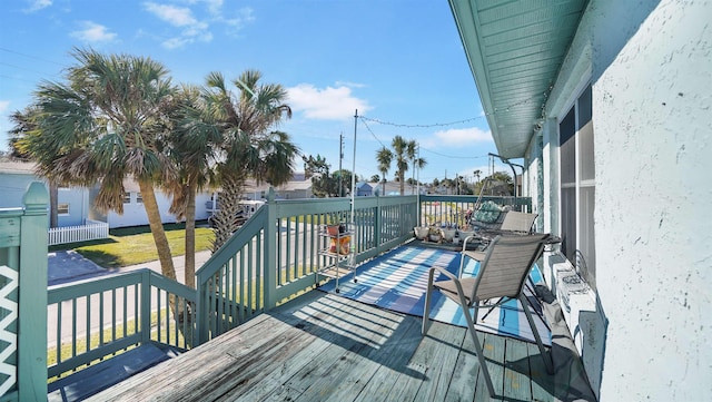 wooden deck with a lawn