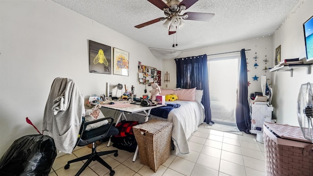 tiled bedroom with a textured ceiling and ceiling fan