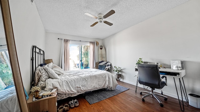 bedroom featuring a textured ceiling, ceiling fan, and wood-type flooring