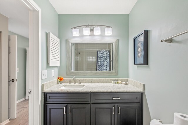 bathroom with a shower with shower curtain and vanity