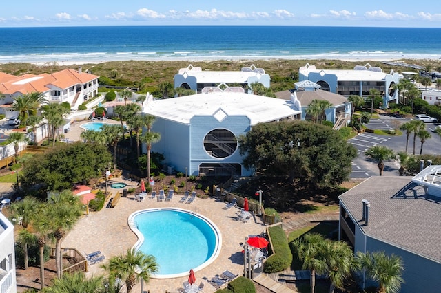 drone / aerial view featuring a view of the beach and a water view