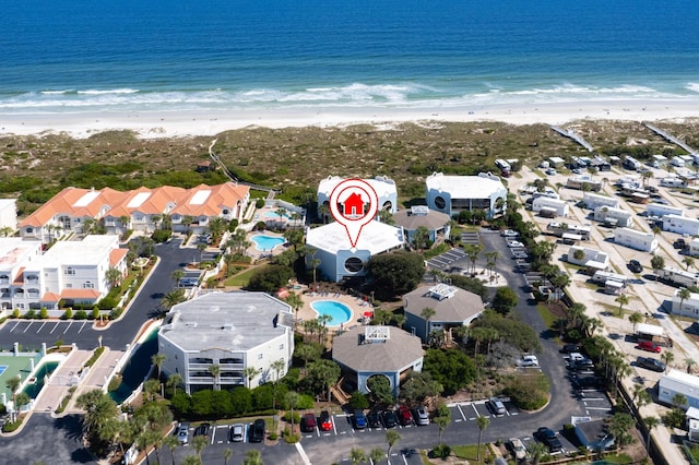 aerial view with a water view and a beach view