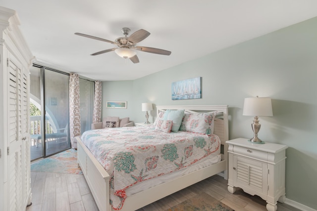 bedroom with access to outside, ceiling fan, and hardwood / wood-style flooring