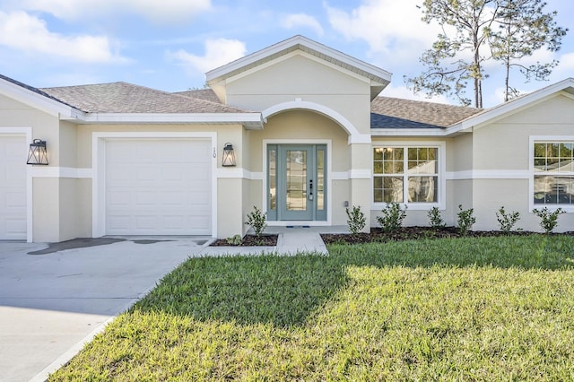 ranch-style home featuring a garage and a front lawn