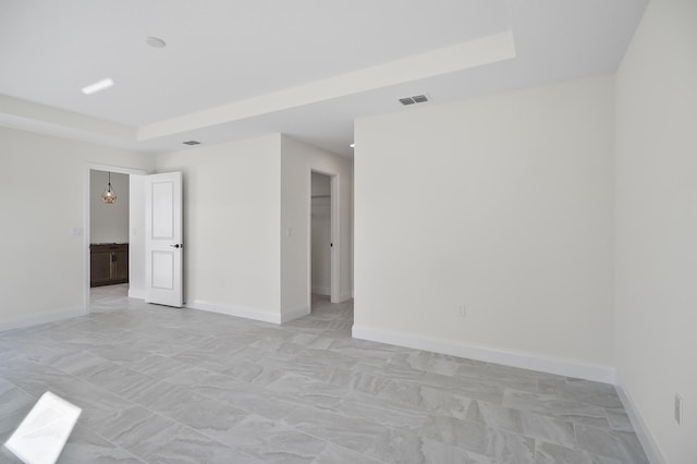 empty room featuring a tray ceiling