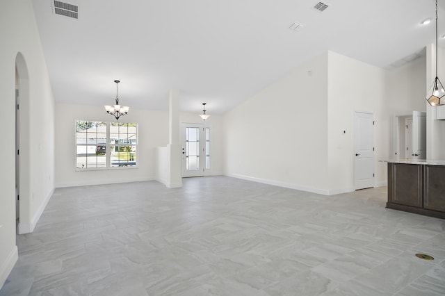 unfurnished living room with a chandelier