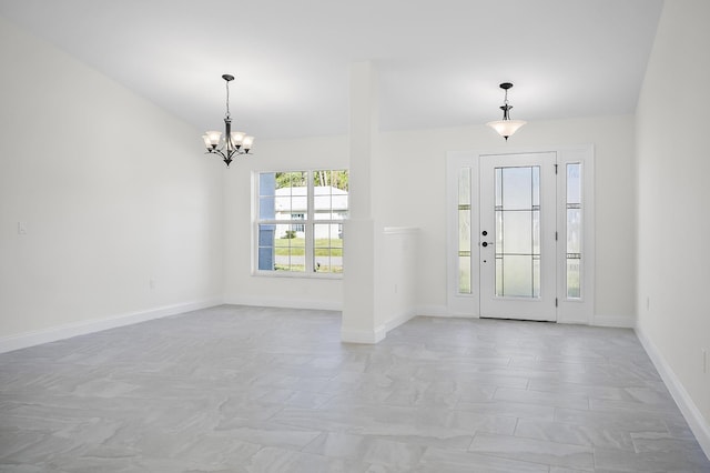 foyer entrance featuring a notable chandelier