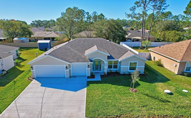 view of front of house featuring a front yard and a garage