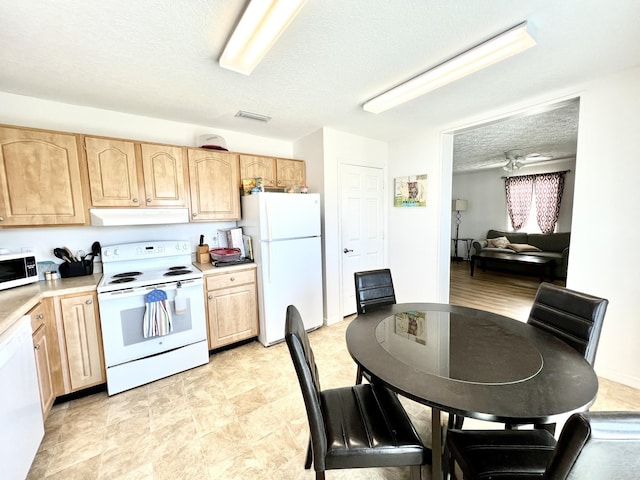 5961 S A1A, Saint Augustine, FL 32080 - kitchen featuring white appliances, light brown cabinets, under cabinet range hood, a textured ceiling, and light countertops