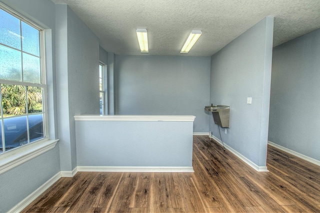 5961 S A1A, Saint Augustine, FL 32080 - unfurnished room featuring dark wood-style flooring and a textured ceiling