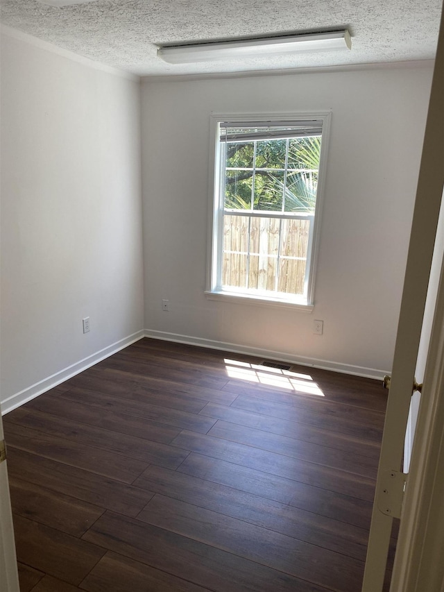 5961 S A1A, Saint Augustine, FL 32080 - spare room featuring dark wood-style floors and a textured ceiling
