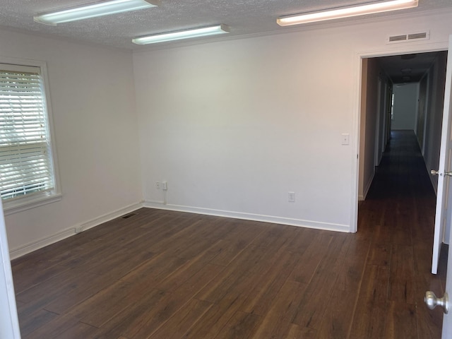 5961 S A1A, Saint Augustine, FL 32080 - empty room with dark wood-style floors and a textured ceiling