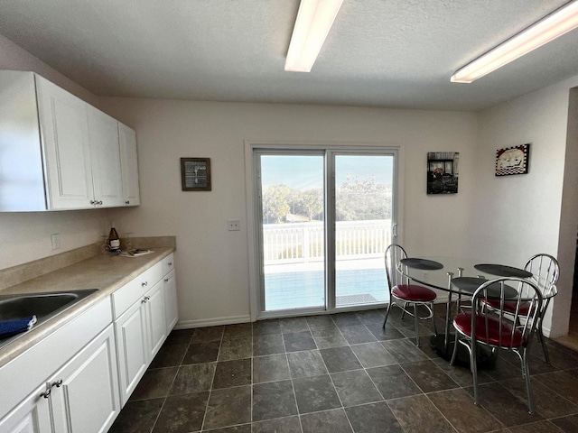 5961 S A1A, Saint Augustine, FL 32080 - kitchen with white cabinetry, light countertops, and a textured ceiling