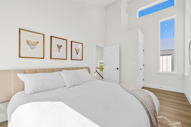 194 Riberia St, Saint Augustine, FL 32084 - bedroom featuring wood finished floors and a towering ceiling