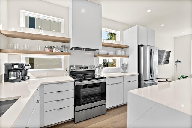 194 Riberia St, Saint Augustine, FL 32084 - kitchen with open shelves, stainless steel appliances, light wood-type flooring, recessed lighting, and white cabinetry