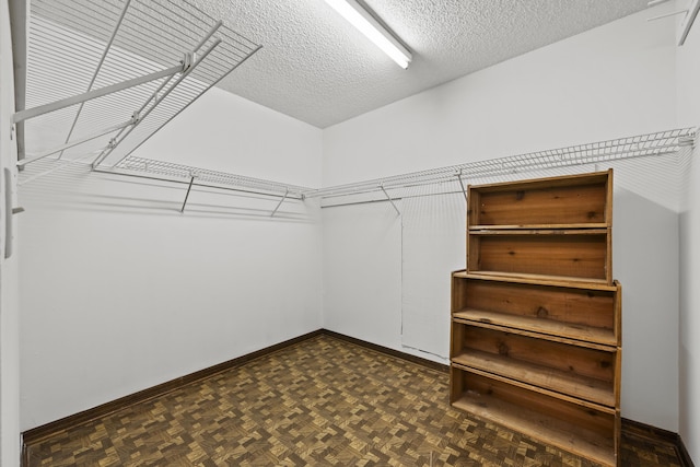 walk in closet featuring dark parquet floors